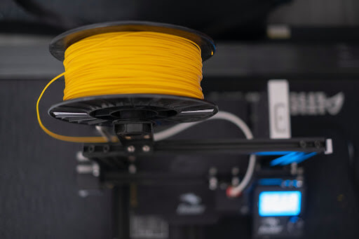 Image Of A Spool Of Yellow Custom Plastic Extrusion Material
